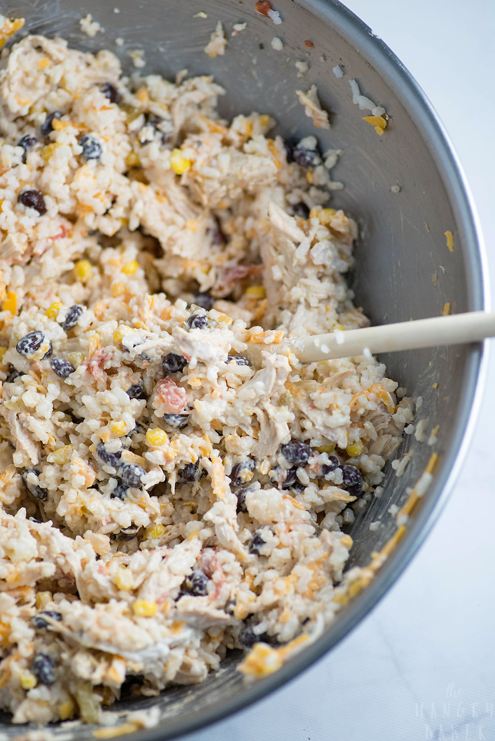 Cheesy Rice, Chicken and Bean Bake - An easy meal packed with flavors! Moist chicken, salsa, gooey cheese, beans and tender rice will please any family!