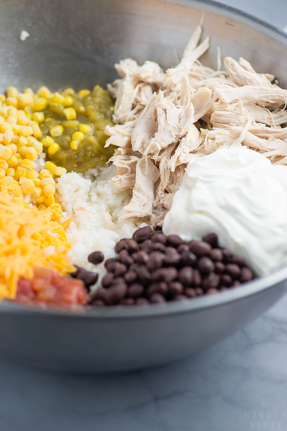 Cheesy Rice, Chicken and Bean Bake - An easy meal packed with flavors! Moist chicken, salsa, gooey cheese, beans and tender rice will please any family!