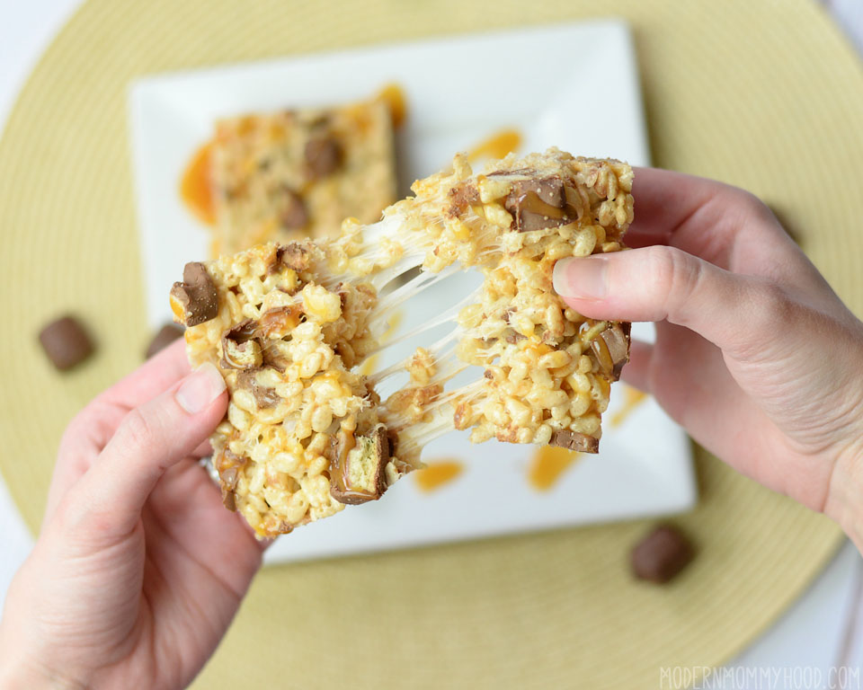 Double Caramel Twix Rice Krispie Treats Recipe - caramel and marshmallow filling with twix bites melted in. Perfect soft and gooey crispy treat!