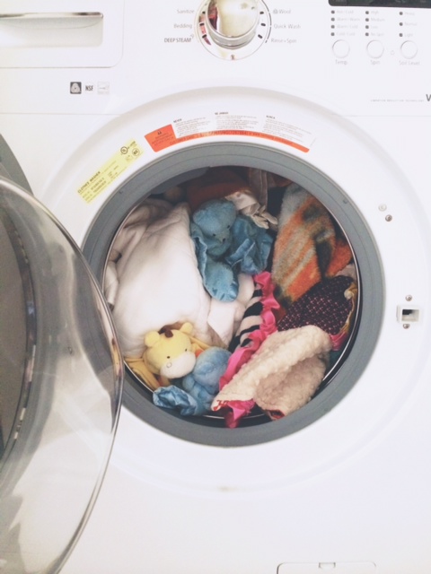 washing machine full of baby bedding